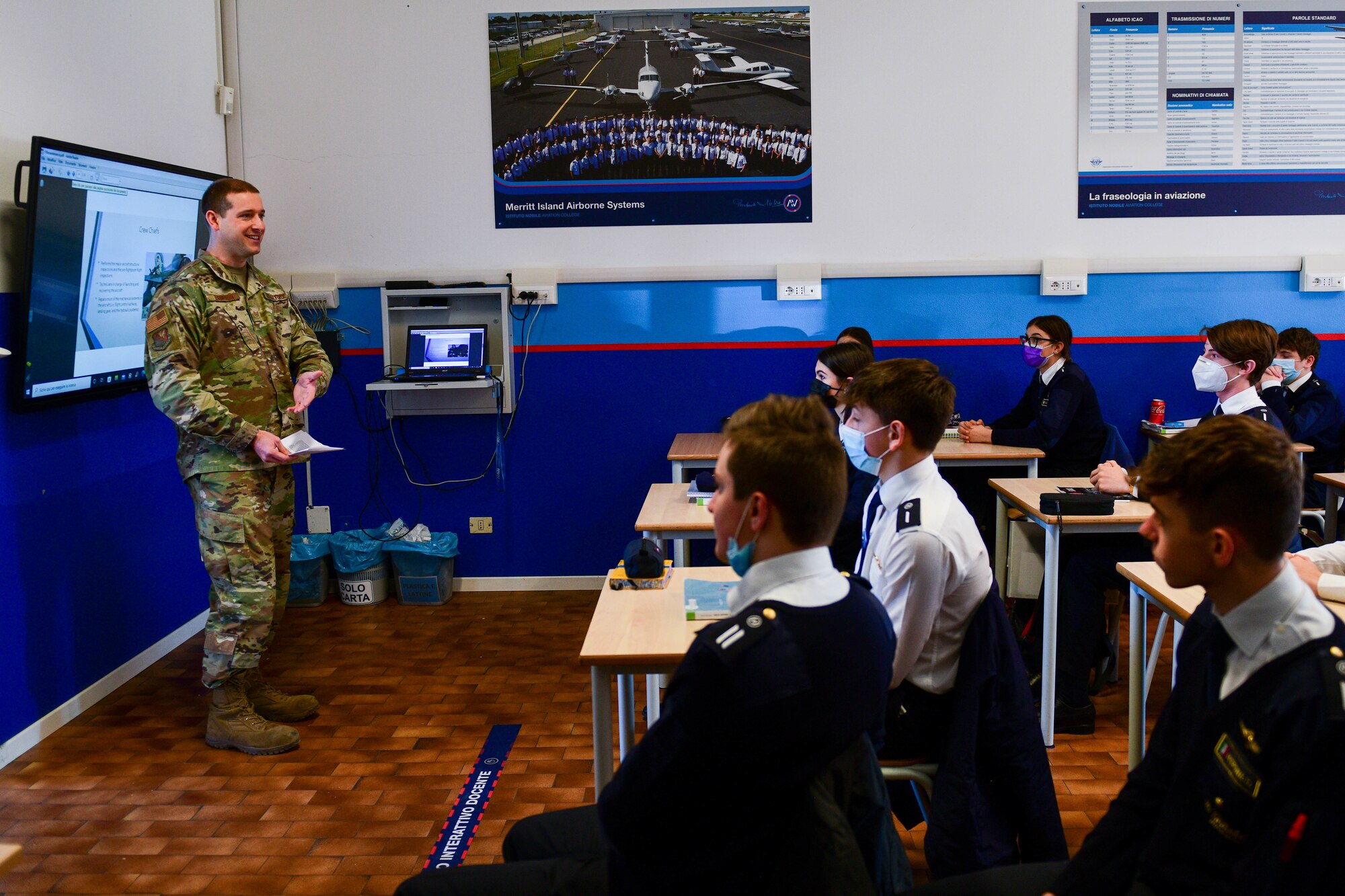 Tech. Sgt. Jacob Thompson, 31st Maintenance Group Quality Assurance inspector, shares his job experiences with high school aeronautical students at the Nobile Aviation college in Udine, Italy, March 8, 2022. A pilot and maintainer from the 31st Fighter Wing and the Italian air force Air Traffic Control Tower commander spoke in front of approximately 60 aeronautical high school students and shared their experiences of being in the military. (U.S. Air Force photo by Senior Airman Brooke Moeder)