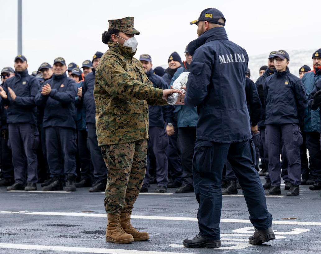 U.S. Marine Corps Staff Sgt. Adimonika Qiokata, 2d Marine Expeditionary Brigade, receives roses from Italian Navy Contrammiraglio Valentino Rinaldi aboard the Italian aircraft carrier Giuseppe Garibaldi in honor of International Women's Day during Exercise Cold Response 2022 on March 8, 2022 in Narvik, Norway. Exercise Cold Response '22 is a biennial Norwegian national readiness and defense exercise that takes place across Norway, with participation from each of its military services, as well as from 26 additional North Atlantic Treaty Organization allied nations and regional partners. (U.S. Marine Corps photo by Staff Sgt. Shawn Coover)