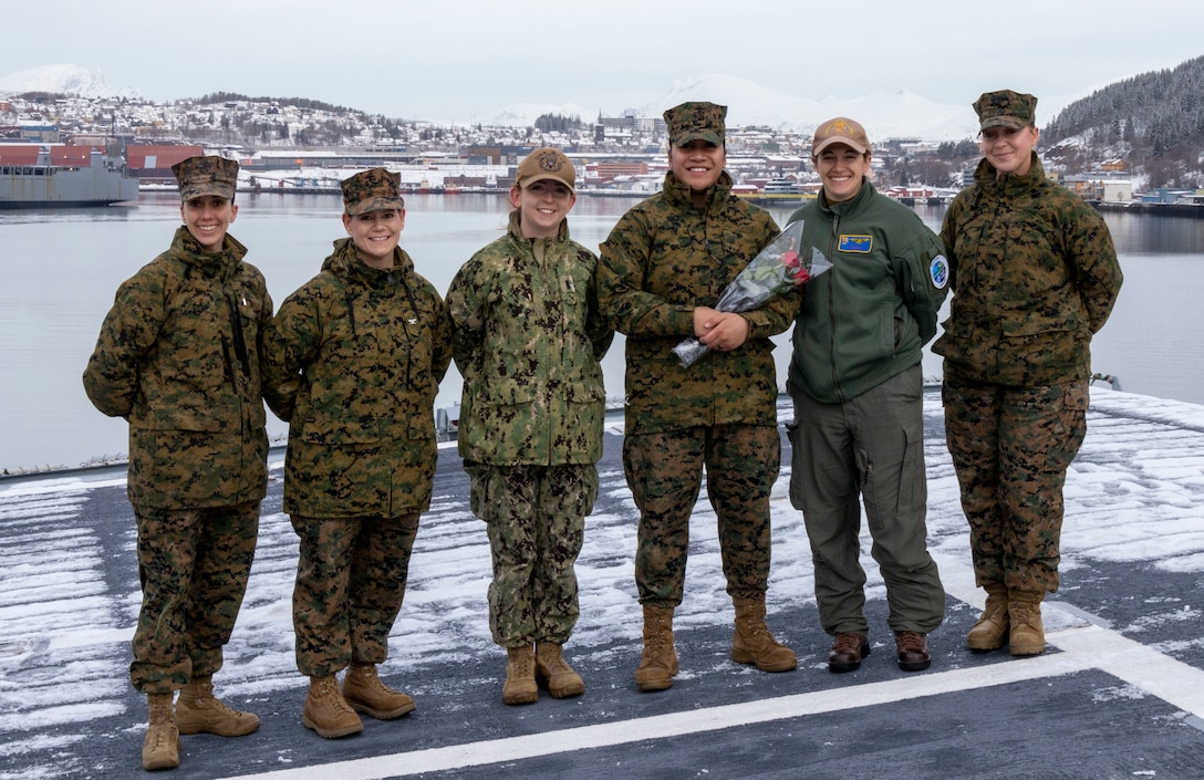 In honor of International Women's day, Italian Navy Contrammiraglio Valentino Rinaldi and U.S. Marine Corps Brig. Gen. Anthony Henderson, commanding General, II Marine Expeditionary Brigade, handed out roses to award six women who stood out at top performers during Exercise Cold Response 2022 on March 8, 2022 in Narvik, Norway. Exercise Cold Response '22 is a biennial Norwegian national readiness and defense exercise that takes place across Norway, with participation from each of its military services, as well as from 26 additional North Atlantic Treaty Organization (NATO) allied nations and regional partners. (U.S. Marine Corps photo by Staff Sgt. Shawn Coover)