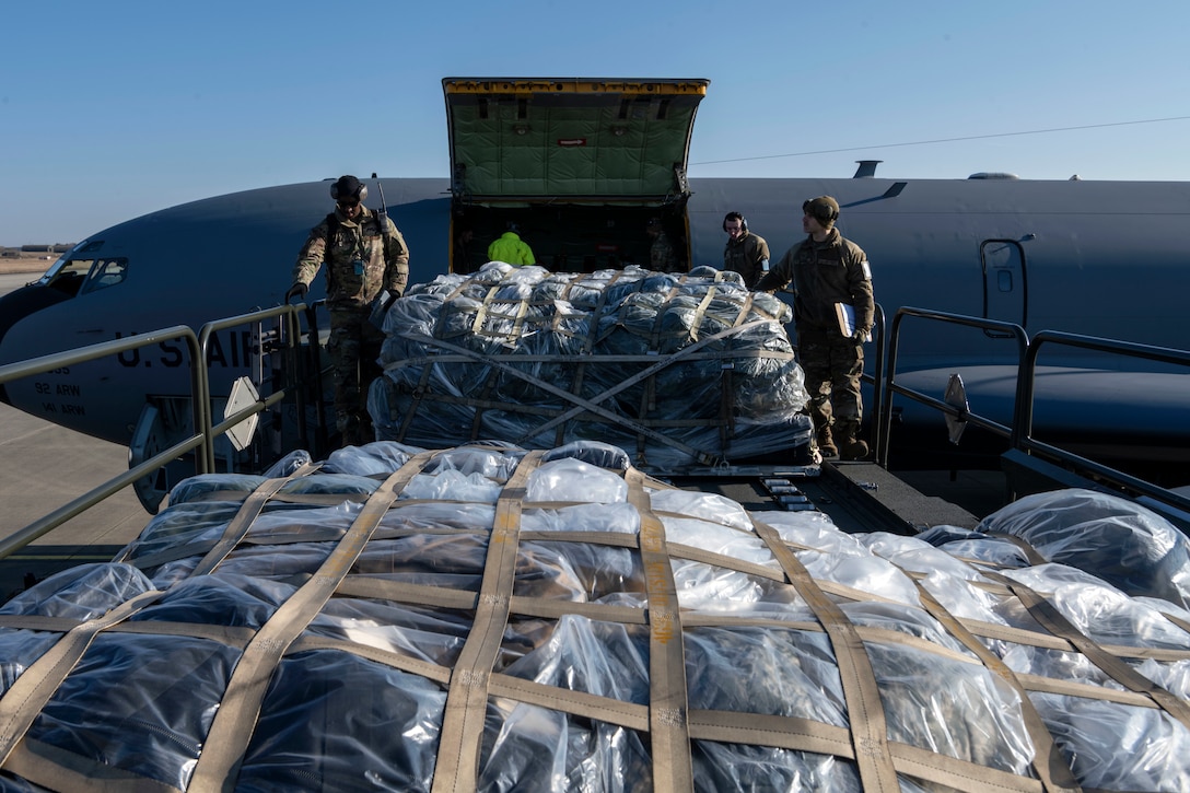 Airmen unload cargo from a KC-135 Stratotanker.