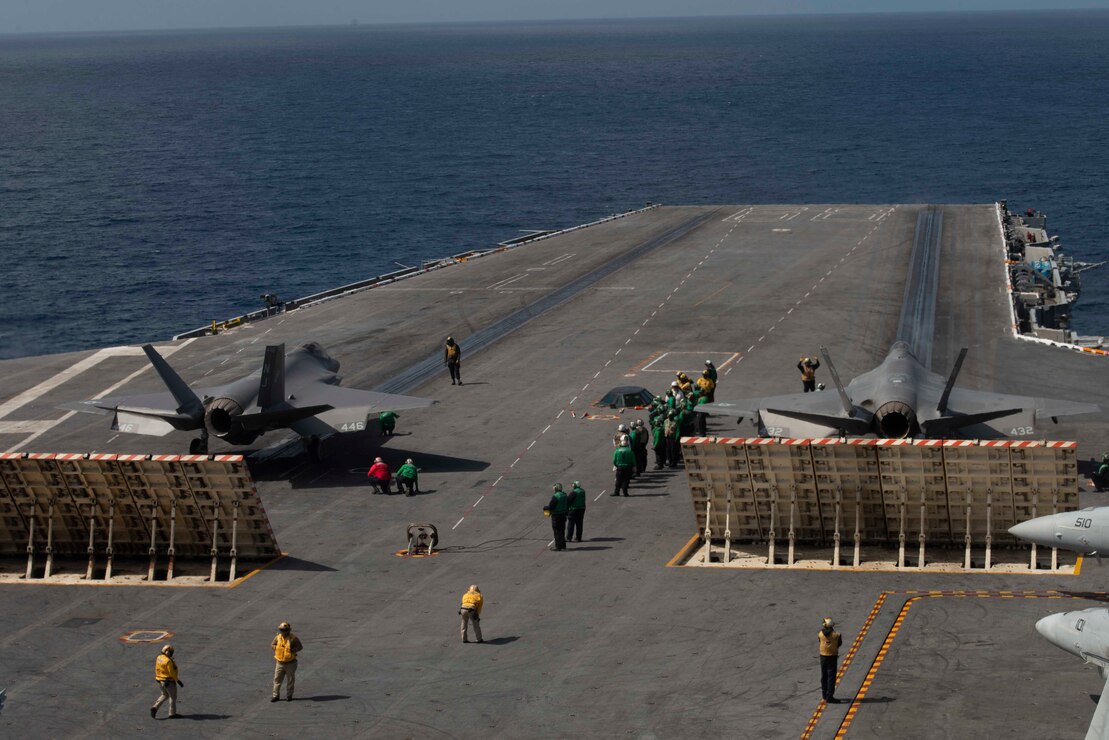 Two F-35C Lightning II's, from the "Rough Raiders" of Strike Fighter Squadron (VFA) 125, prepare to launch off of the flight deck of the aircraft carrier USS Nimitz (CVN 68).