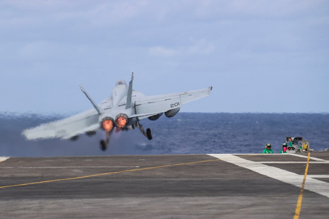 An F/A-18E Super Hornet, assigned to the "Tophatters" of Strike Fighter Squadron (VFA) 14, launches from the flight deck of the Nimitz-class aircraft carrier USS Abraham Lincoln (CVN 72).