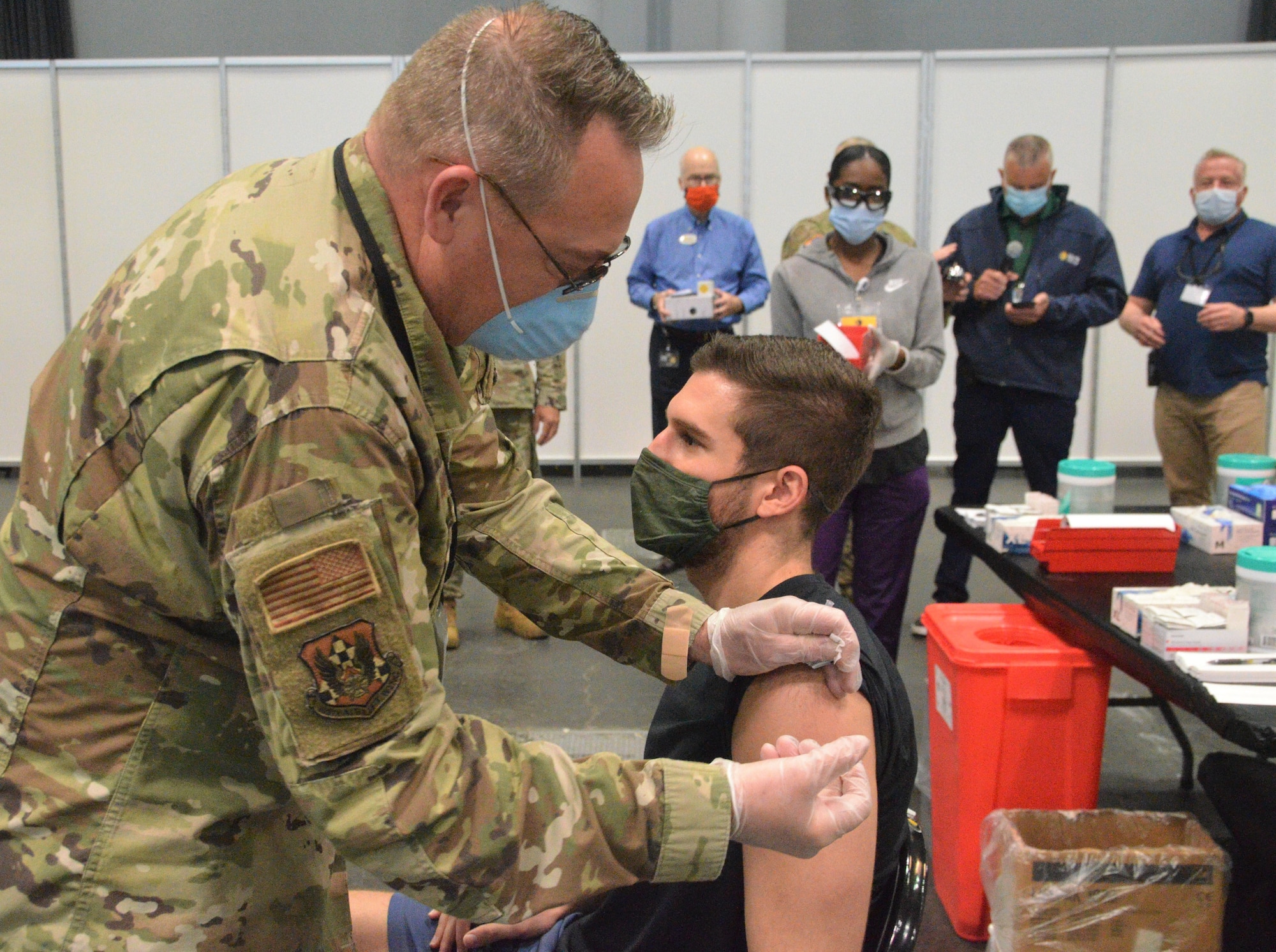 Air Force Lt. Col. John Reynolds, a member of the New York Air National Guard's 105th Airlift Wing, vaccinates Tom Pescatore May 20, 2021 at  the Jacob Javits Convention Center in New York City. Pescatore's injection was the 600,000 shot administered at the massive vaccination site established and staffed by the New York National Guard.