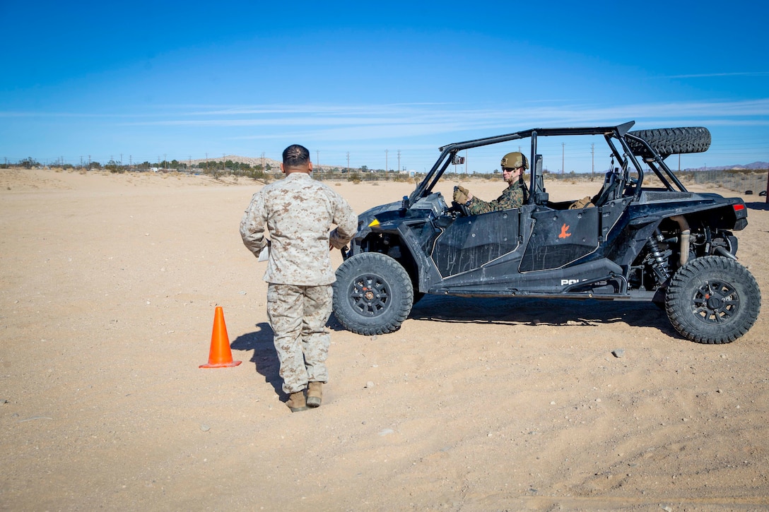 U.S. Marine Corps Sgt. Maj. Troy E. Black, the 19th Sergeant Major of the Marine Corps, receives instructions from Sgt. Miguel Cervantes Campos, a motor transport Marine, during a Polaris Razor all-terrain vehicle licensing course at Marine Corps Air Ground Combat Center, Twentynine Palms, California, March 2, 2022. The Sergeant Major of the Marine Corps attended the Polaris Razor licensing course to maximize freedom of movement in the training areas surrounding the station. The course is designed to introduce Marines to the all-terrain vehicle, and familiarize them to its capabilities and safety considerations. (U.S. Marine Corps photo by Staff Sgt. Victoria Ross)