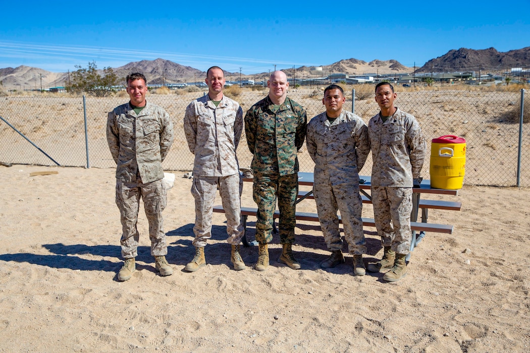 U.S. Marine Corps Sgt. Maj. Troy E. Black, the 19th Sergeant Major of the Marine Corps, poses for a photo with motor transport Marines upon completion of the Polaris Razor licensing course at Marine Corps Air Ground Combat Center, Twentynine Palms, California, March 2, 2022. The Sergeant Major of the Marine Corps attended the course to maximize freedom of movement in the training areas surrounding the station. The course is designed to introduce Marines to the all-terrain vehicle, and familiarize them to its capabilities and safety considerations. (U.S. Marine Corps photo by Staff Sgt. Victoria Ross)