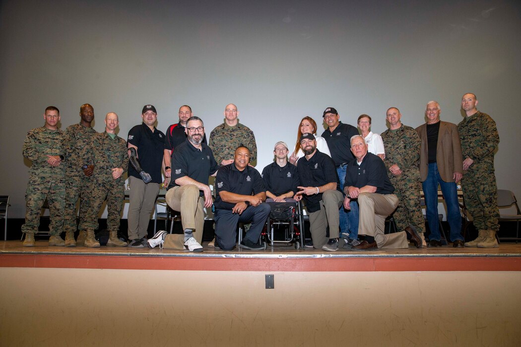 U.S. Marine Corps Sgt. Maj. Troy E. Black, the 19th Sergeant Major of the Marine Corps, poses for a group photo with veterans at a Troops First town hall at Marine Air Ground Combat Center, Twentynine Palms, California, March 2, 2022. The Sergeant Major of the Marine Corps spoke to Marines about talent management, force design, human performance and the importance of staying connected. The Troops First Foundation was created to develop, operate and support wellness, quality of life and event-based initiatives for post-9/11 combat-injured Warriors.(U.S. Marine Corps photo by Staff Sgt. Victoria Ross)