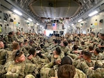 National Guard Soldiers from the Minnesota-based 34th Infantry Division pack a U.S. Air Force-operated C-17 in August following the completion of their mission in Kabul, Afghanistan. Deployed in support of Operation Spartan Shield, about 400 Soldiers from 34th ID were temporarily relocated to Kabul, Afghanistan, and have since arrived safely in Kuwait, where they are assigned. (U.S. Army photo by Capt. Charles Anderson)