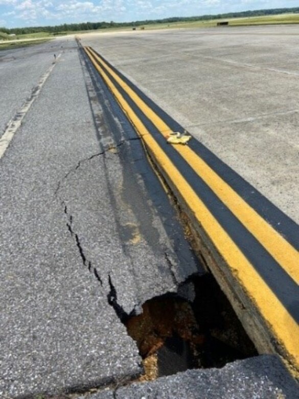 A sinkhole, a depression in the ground caused by the collapse of the surface layer, causes a partial collapse on Taxiway Echo at Joint Base Andrews, Md., June 15, 2021.