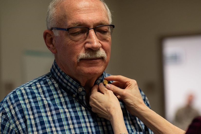 Gary Goldman accepts 50 Year Length of Service Awards and Federal Service Pin