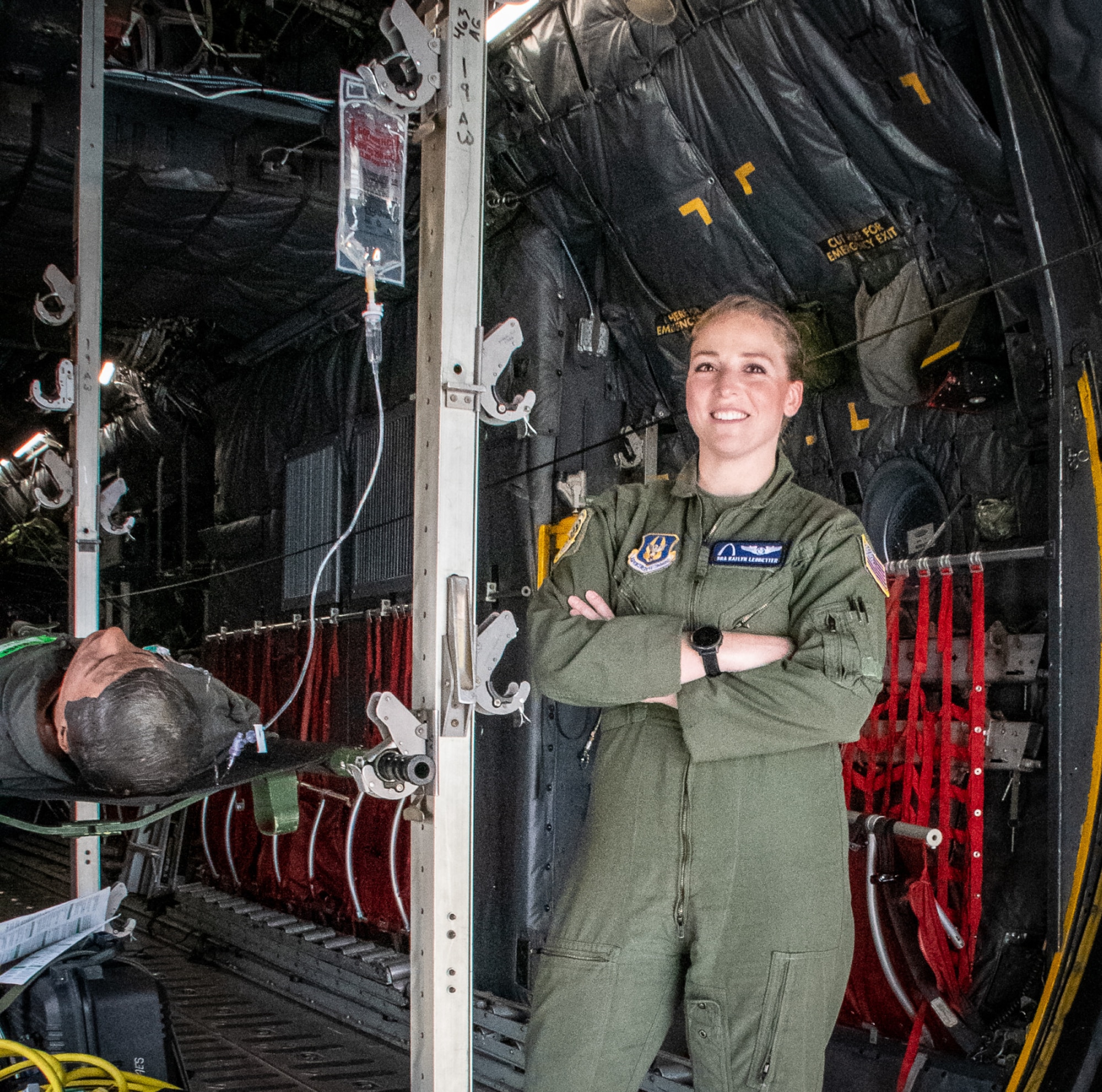 Senior Airman Katlyn Ledbetter poses for an environmental photo in the C-130 Hercules aeromedical evacuation (AE) fuselage trainer (FuT).