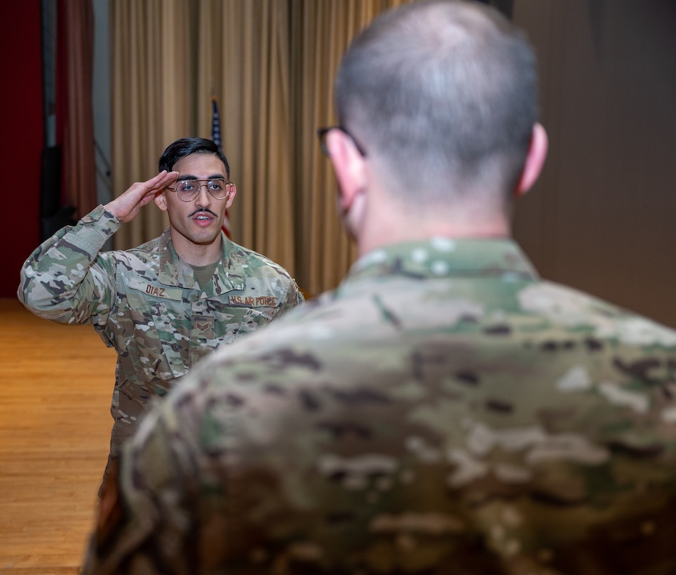 Senior Airman Victor Diaz, 28th Security Forces Squadron military working dog (MWD) handler, reports to Maj. Rudolph McIntyre IV, 28th SFS commander, finalizing his working dog scenario at Ellsworth Air Force Base, S.D., March 7, 2022.
