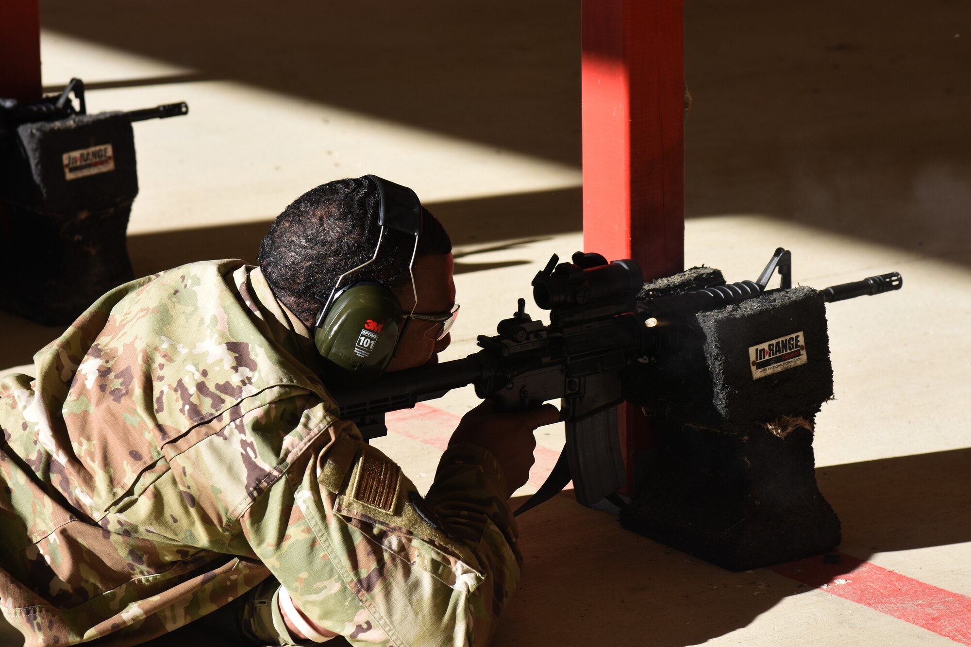 An Airman with the 908th Airlift Wing fires an M4 rifle from a prone position during a firearms qualification