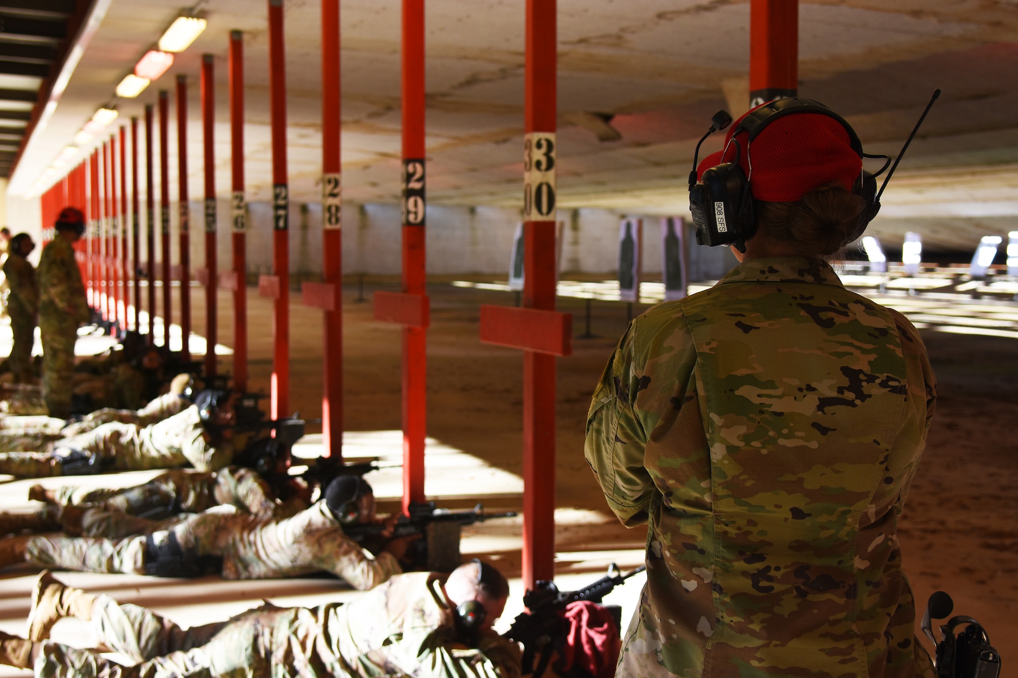 An instructor watches over the firing line.