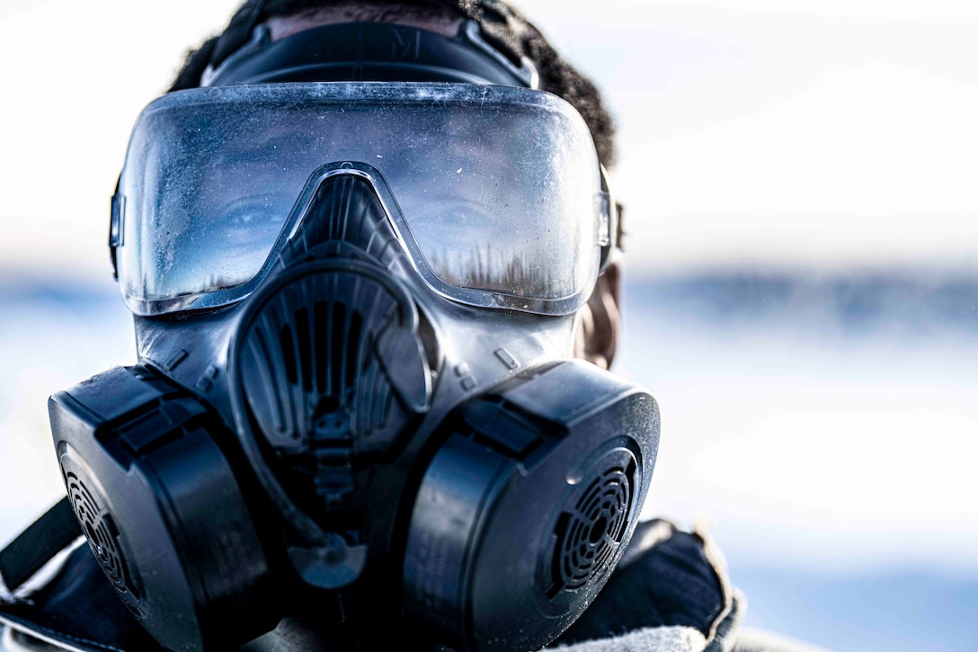 A soldier wearing a gas mask.