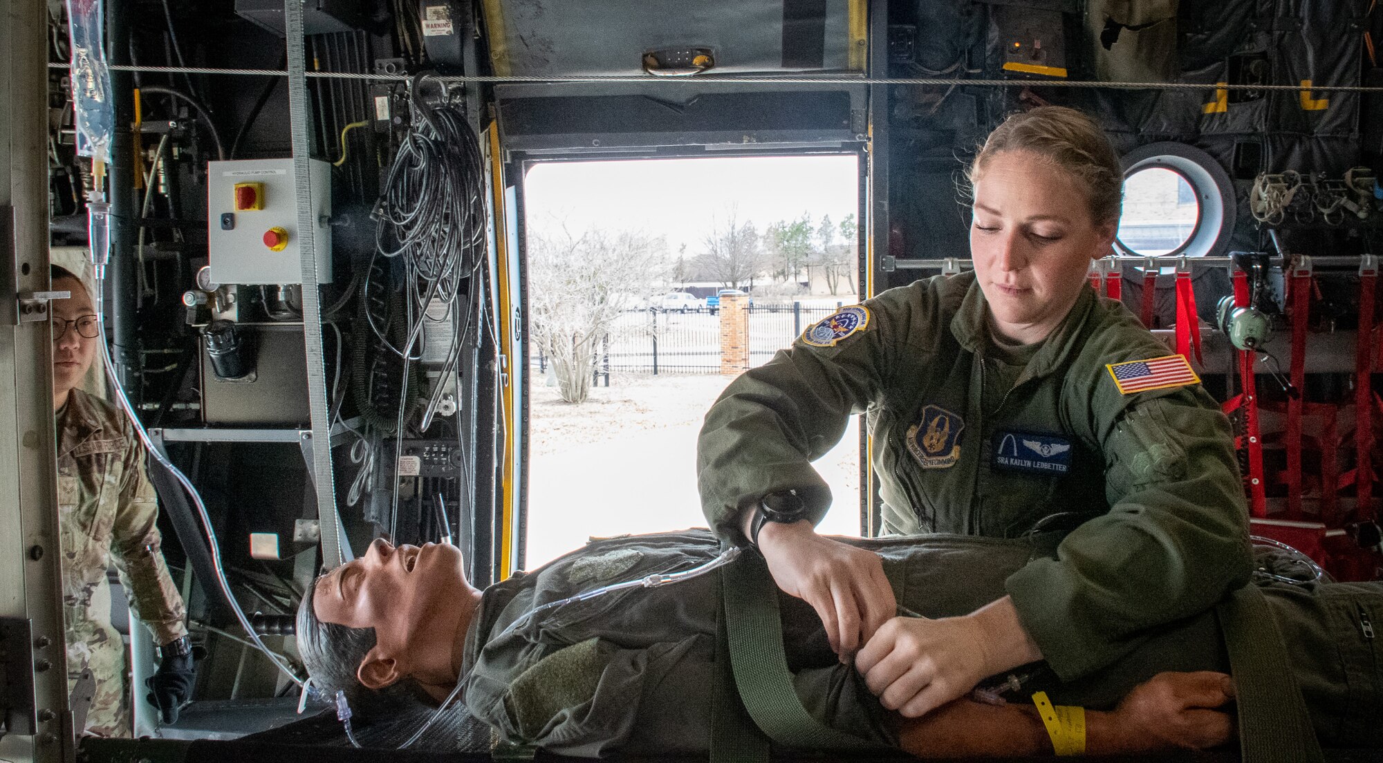Senior Airman Katlyn Ledbetter, 932nd Aeromedical Evacuation Squadron AE technician, trains fellow AE technician Senior Airman Tiffany Tsui on in-flight medical care procedures and the administration of intravenous fluids on a medical training mannequin.