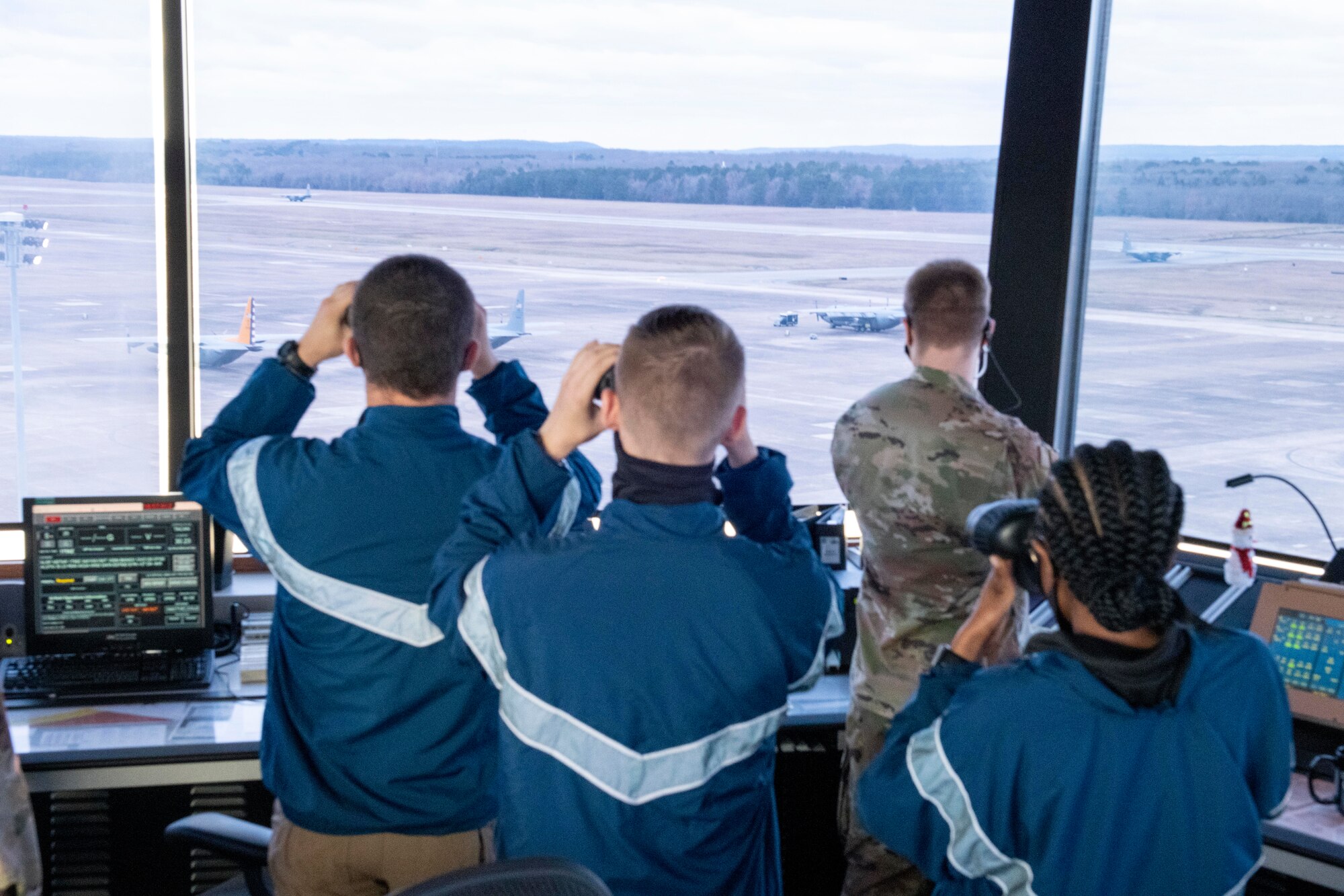 Air Force Reserve Officer Training Corps cadets from the University of Memphis Detachment 785 look through binoculars at the flightline