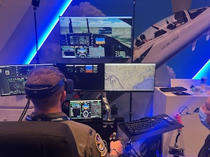 U.S Air Force 1st Lieutenant Justin Treinish, 50th Flying Training Squadron T-38 Instructor Pilot, flies in the T-7A flight simulator, March 3, 2022, at the AFA Warfare Symposium in Orlando, Florida. (U.S. Air Force photo by 2nd Lieutenant Peyton Craven)
