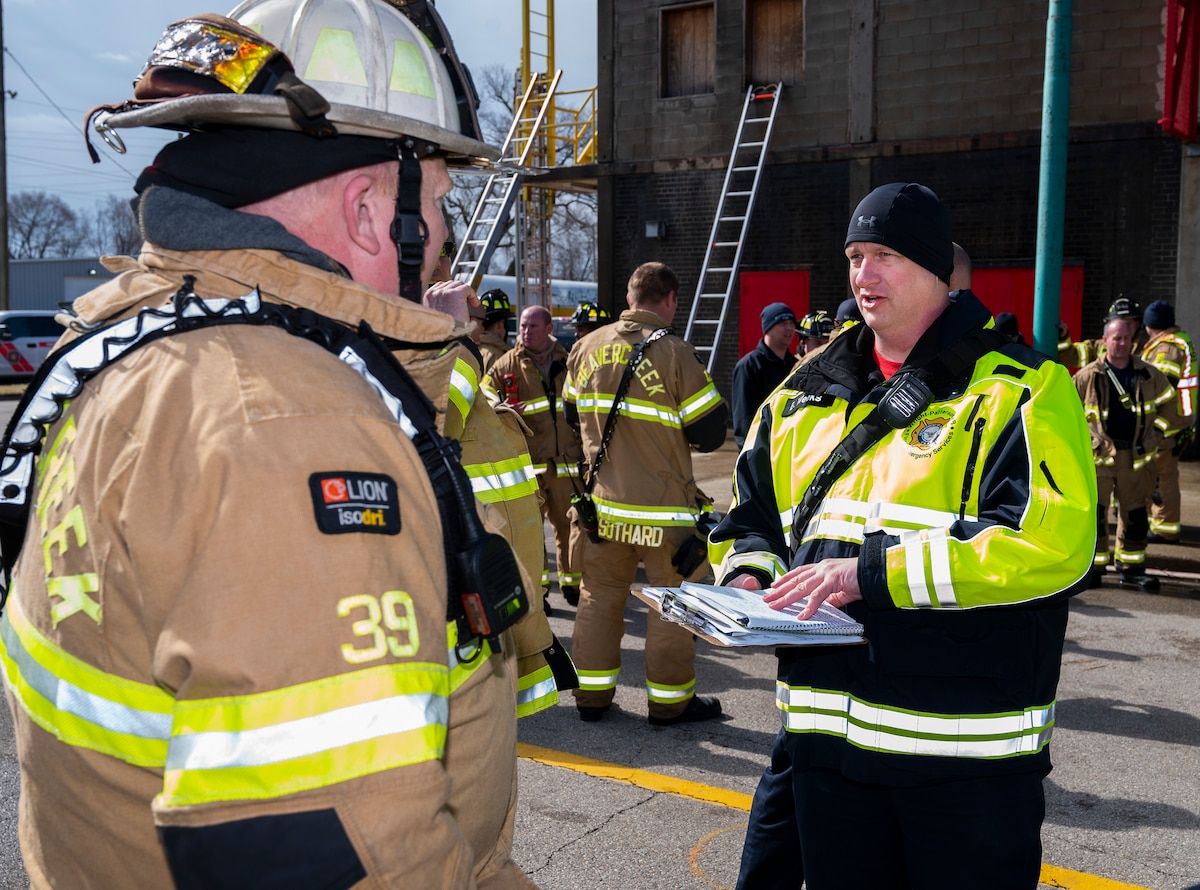 Assistant Chief Bryan Weeks (right), Wright-Patterson Air Force Base Fire Department, debriefs Division Chief Scott Dorsten, Beavercreek Township Fire Department, following an exercise March 3, 2022, at the Dayton Fire Training Center. The Beavercreek and WPAFB departments are mutual-aid partners, lending each other a hand when needed. (U.S. Air Force photo by R.J. Oriez)