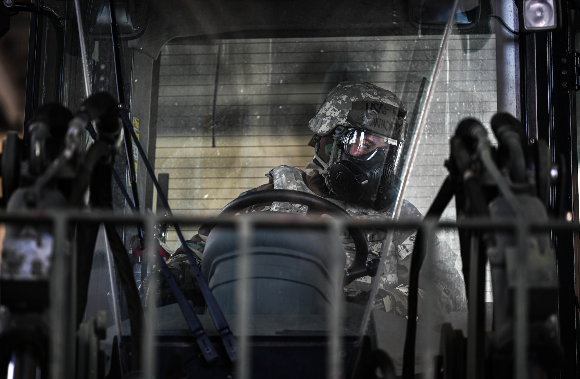 Airmen 1st Class Shannon McLellan, 647th Logistics Readiness Squadron combat mobility flight team member, operates a forklift while in Mission-Oriented Protective Posture gear during Exercise TROPIC FURY at Joint Base Pearl Harbor-Hickam, Hawaii, March 8, 2022. CMF Airmen tested their ability to effectively palletize and transport cargo while in mission-oriented protective posture gear during a simulated chemical, biological, radiological, nuclear and high yield explosives event. (U.S. Air Force photo by Staff Sgt. Alan Ricker)