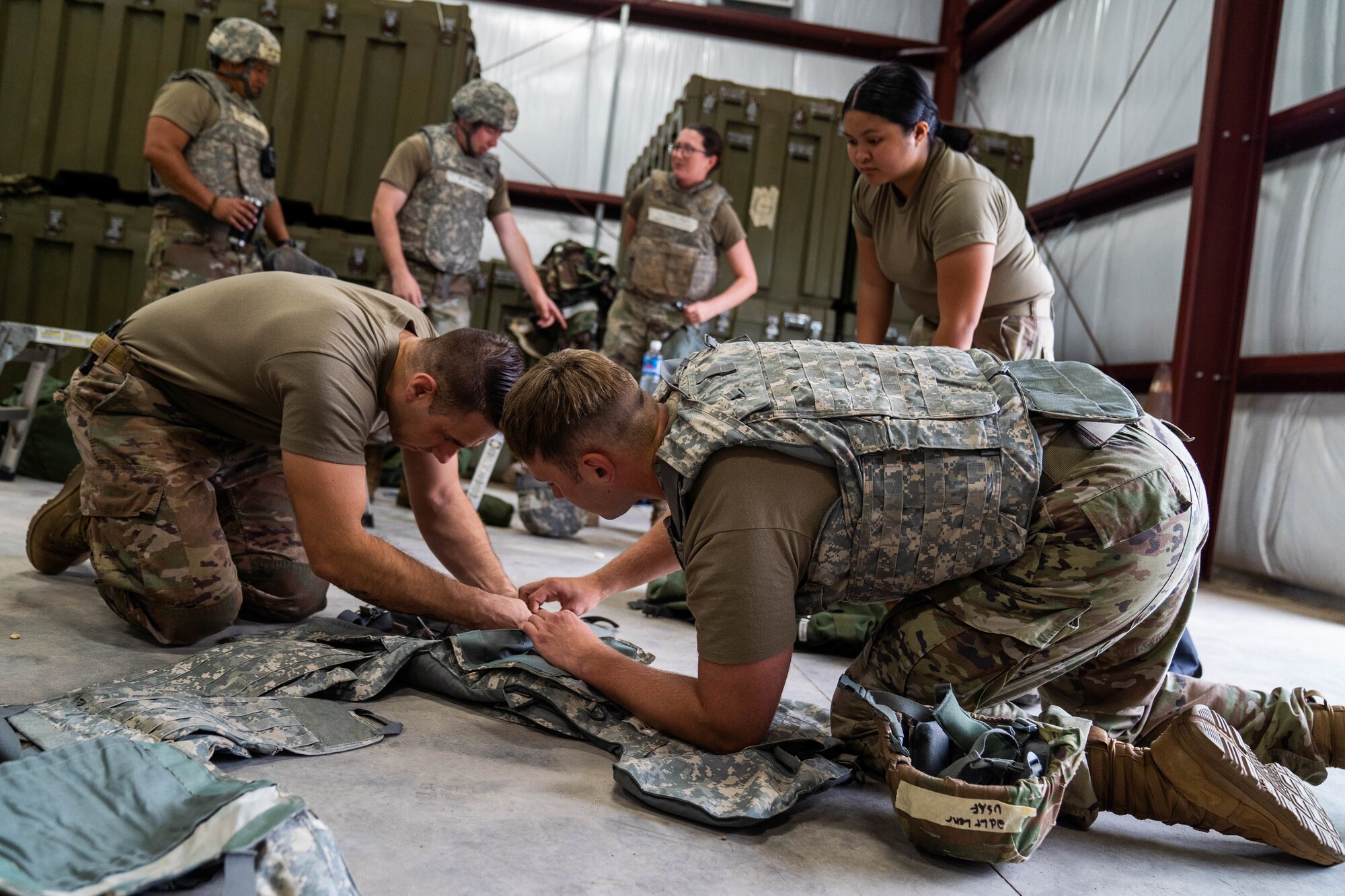 Airmen assigned to 647th Civil Engineer Squadron assemble a kevlar vest in preparation for training Exercise TROPIC FURY at Joint Base Pearl Harbor-Hickam, Hawaii, March 8, 2022. The third phase of the exercise tests the 15th Wing’s capability to plan, generate and execute a deployment tasking and the ability to establish a forward operating base in a combat environment. (U.S. Air Force photo by Airman 1st Class Makensie Cooper)