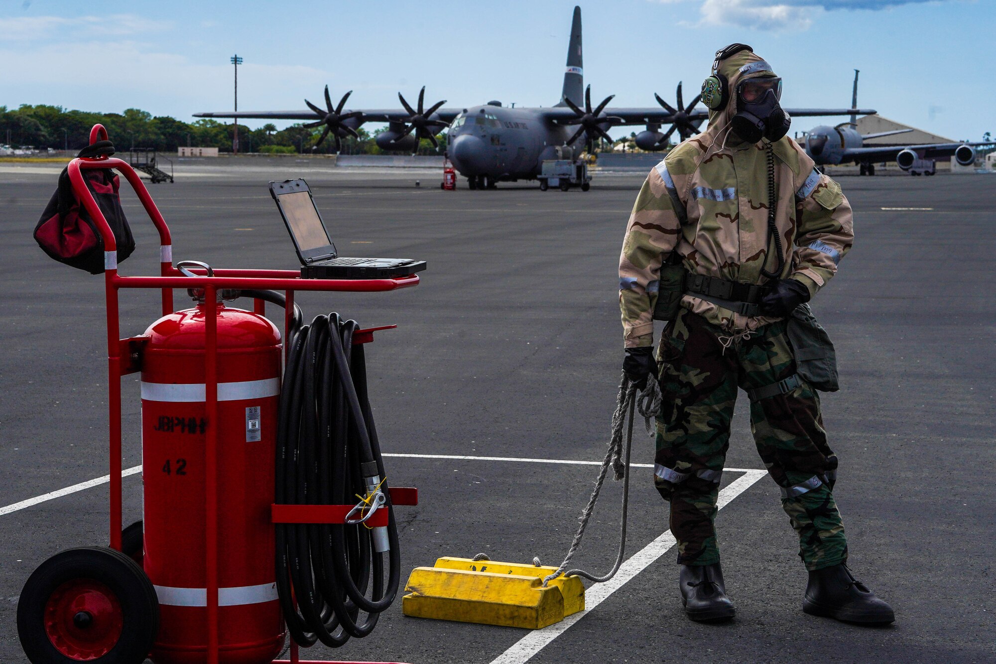 Staff Sgt. Justin Rigby, 15th Aircraft Maintenance Squadron communication navigation defensive systems craftsman, prepares to place tire chocks under a C-17 Globemaster III during Exercise TROPIC FURY at Joint Base Pearl Harbor-Hickam, Hawaii, March 8, 2022. 15th Maintenance Group Airmen conduct a variety of tasks after an aircraft lands including placing chocks and providing power to the aircraft. (U.S. Air Force photo by Airman 1st Class Makensie Cooper)