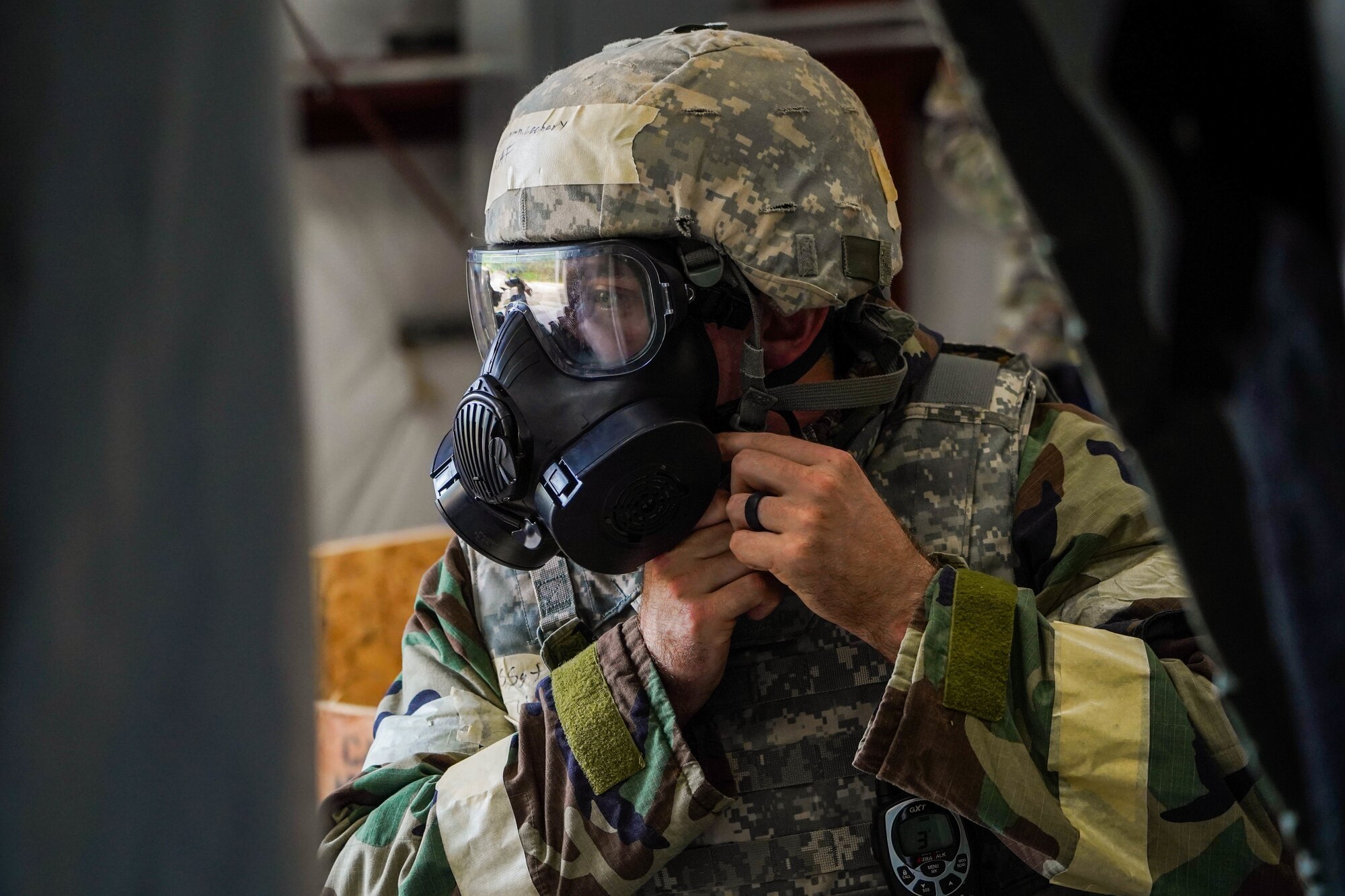 Staff Sgt. Zachary Stutzman, 647th Civil Engineer Squadron electrical journeyman, dons Mission-Oriented Protective Posture response gear during Exercise TROPIC FURY at Joint Base Pearl Harbor-Hickam, Hawaii, March 8, 2022. MOPP gear protects against chemical agents during chemical, biological and nuclear scenarios and protects Airmen from harmful substances. (U.S. Air Force photo by Airman 1st Class Makensie Cooper)
