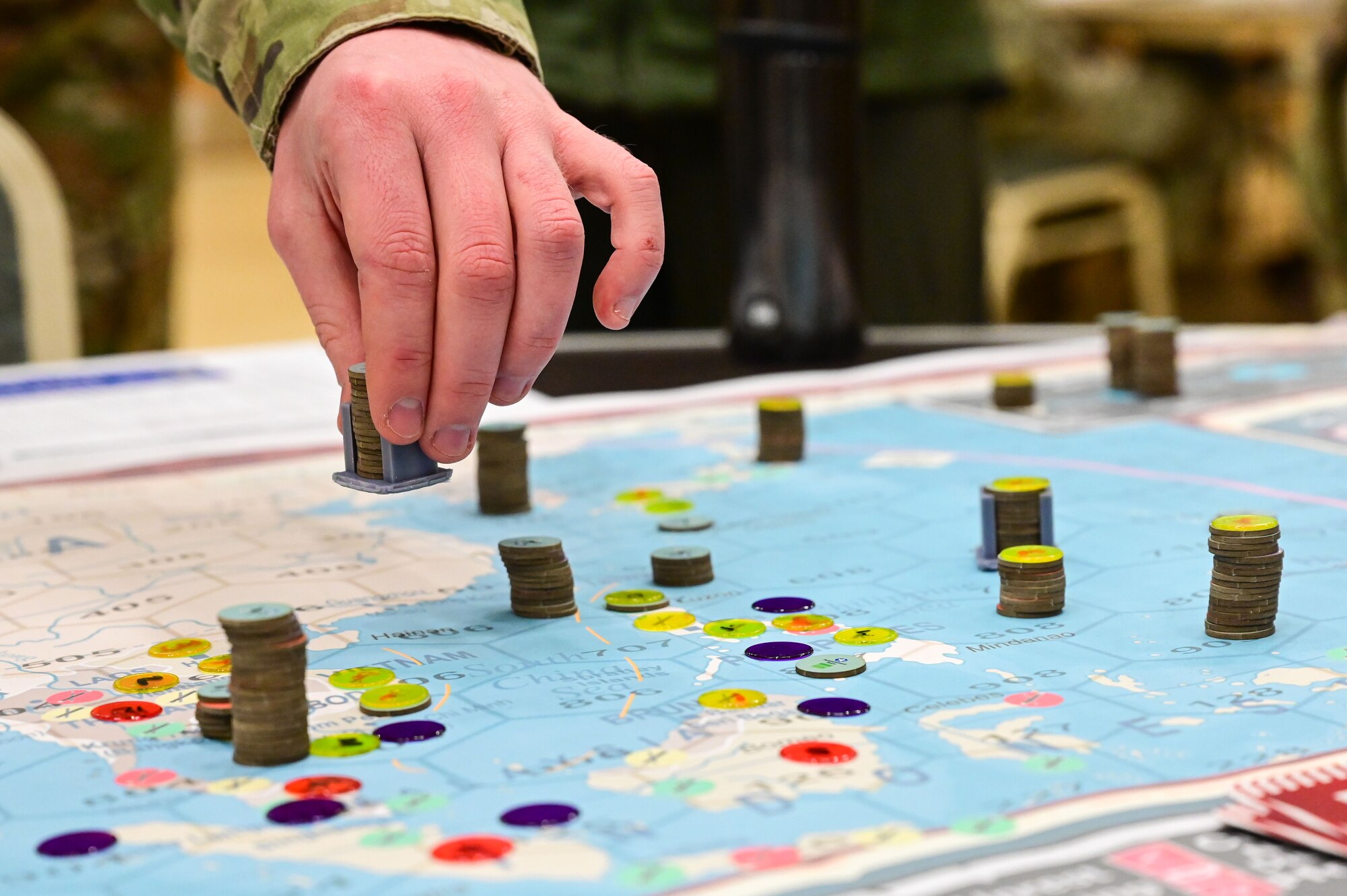 An Airman assigned to the 19th Airlift Wing moves a game piece on the board during a KingFish Agile Combat Employment exercise