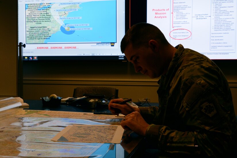 Capt. Brandon Sweeney, current operations officer, Pennsylvania National Guard, marks unit locations on a map of Pennsylvania during a staff training course March 8. The trial course, hosted by U.S. Northern Command, will be the Phase II of the Joint Staff Training Course. The course trained staff on emergency preparedness using a notional Category 2 Hurricane scenario.