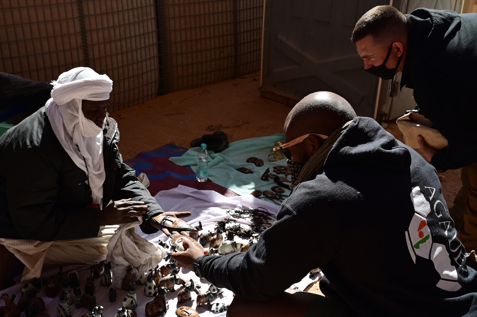 U.S. Service members shop during a bazaar at Nigerien Air Base 201, Agadez, Niger, Feb. 27, 2022. U.S. service members purchased approximately 10,532,000 West African CFA francs ($18K USD) worth of goods during the bazaar. Events like these enhance U.S., Niger relationships and stimulate local economic development. (U.S. Air Force photo by Tech. Sgt. Stephanie Longoria)
