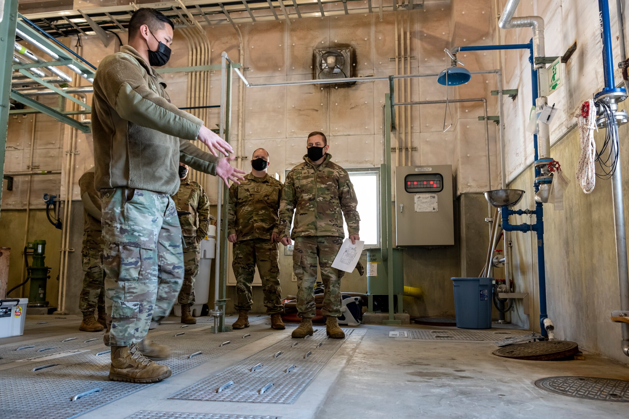 Airman explaining the process of how the wastewater is cleaned and treated from start to finish.