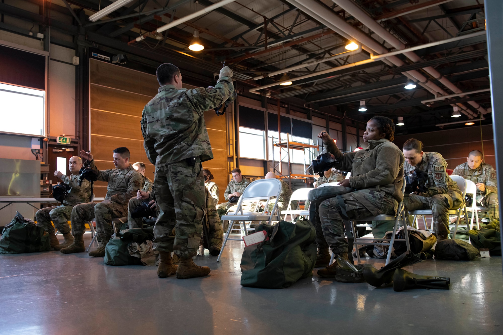 U.S. Air Force Staff Sgt. Nathan Hoskins, 423rd Civil Engineer Squadron NCO in charge of training, instructs a chemical, biological, radiological and nuclear (CBRN) defense survival skills course at RAF Alconbury, England, March 8, 2022. The course consists of individual knowledge-based and demonstration performance objectives that provide an in-depth education on CBRN defense hazards and protective actions. (U.S. Air Force photo by Senior Airman Jennifer Zima)