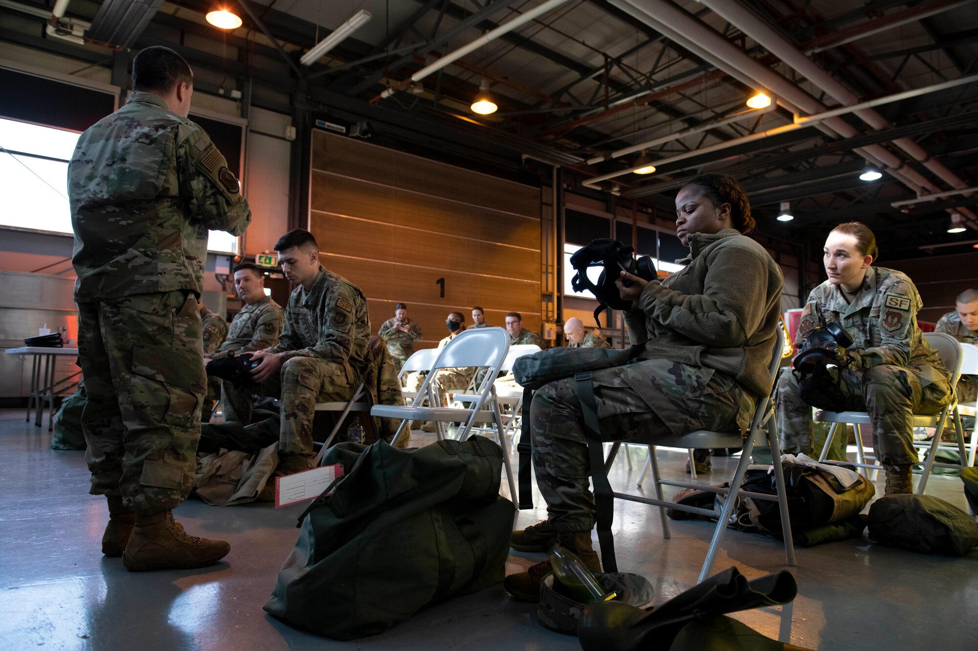 U.S. Air Force Staff Sgt. Nathan Hoskins, 423rd Civil Engineer Squadron NCO in charge of training, instructs a chemical, biological, radiological and nuclear (CBRN) defense survival skills course at RAF Alconbury, England, March 8, 2022. The course consists of individual knowledge-based and demonstration performance objectives that provide an in-depth education on CBRN defense hazards and protective actions. (U.S. Air Force photo by Senior Airman Jennifer Zima)