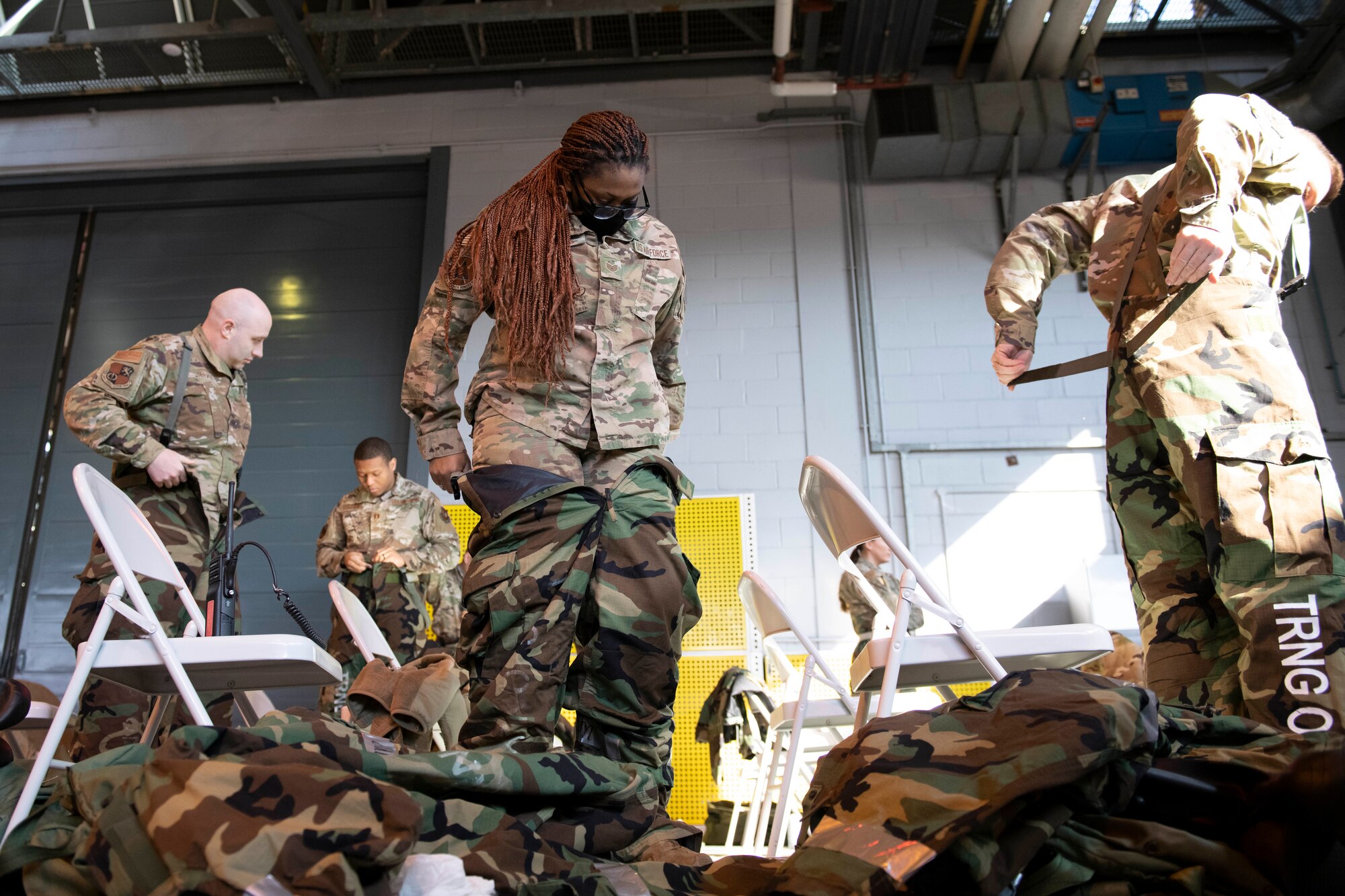 U.S. Air Force Airmen don their mission-oriented protective posture (MOPP) gear during a chemical, biological, radiological and nuclear (CBRN) defense survival skills training course at RAF Alconbury, England, March 8, 2022. Airmen are refreshed on vital skills that may save their lives while on duty by learning proper ways to put on protective equipment in a timely and efficient manner. (U.S. Air Force photo by Senior Airman Jennifer Zima)