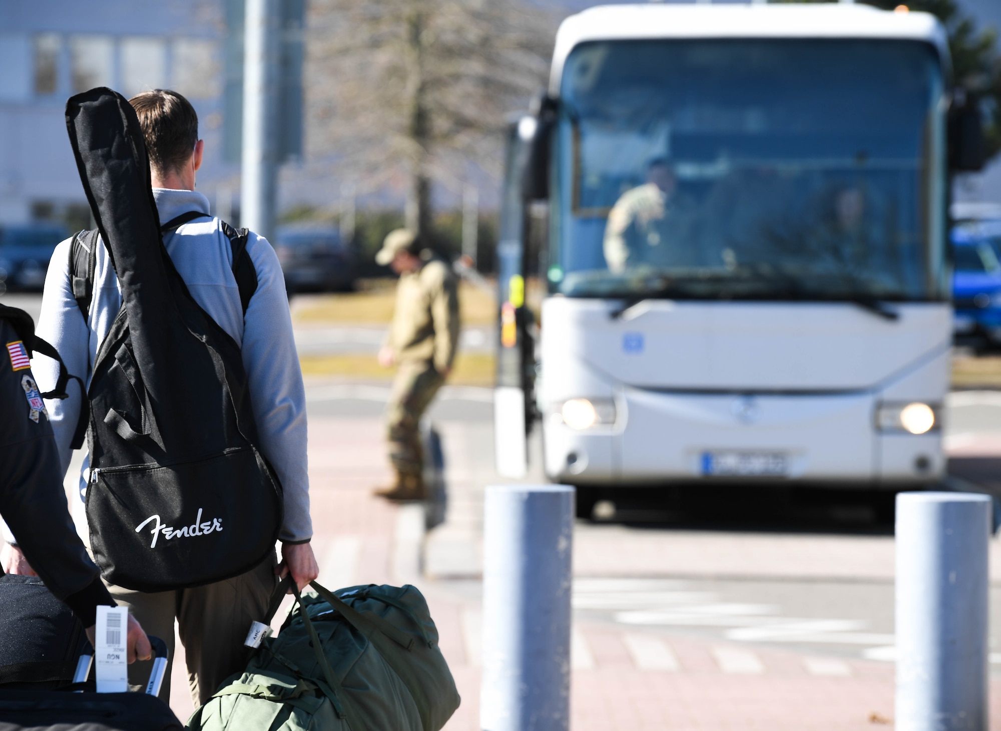 U.S. Air Force Lt. Col. Paul Griffith, 12th Air Force chief of theater security cooperation assigned to Davis Monthan Air Force Base, Arizona, walks to a shuttle bus at Ramstein Air Base, Germany, March 8, 2022. RAB is experiencing a surge in the arrival of service members sent here for mission support. Ground transportation Airmen are supporting newcomers with transportation services around-the-clock through a shuttle bus. The bus is available to transport them to places such as the in-processing center, commissary and medical appointments. (U.S. Air Force photo by Airman 1st Class Jared Lovett)