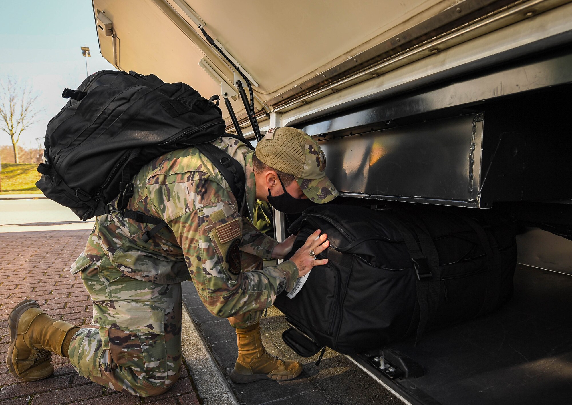 U.S. Air Force 2nd Lt. Andrew Bogdan, 47th Comptroller Squadron financial analysis flight commander assigned to Laughlin Air Base, Texas, loads his luggage onto a shuttle bus at Ramstein Air Base, Germany, March 8, 2022. Service members are increasingly arriving at RAB for mission support, and  ground transportation Airmen are available around-the-clock to bring them where they need to be through  a shuttle bus service. A QR code is available at on-base bus stops to provide bus stop times.  (U.S. Air Force photo by Airman 1st Class Jared Lovett)