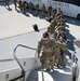 Soldiers from 1st Battalion, 109th Infantry Regiment, board a plane at Harrisburg International Airport in Middletown, Pa., on March 4, 2022, as they begin a deployment to the Middle East.
