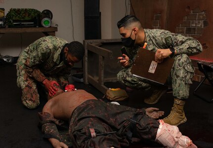 220224-N-DQ752-0016 JOINT BASE SAN ANTONIO FT. SAM HOUSTON, Texas (Feb. 24, 2022) Hospital Corpsman 1st Class David Rojas, from Los Angeles (left), proctors a Tactical Combat Casualty Care exam for Seaman Recruit Antonio Keys, from Memphis, Tenn., as part of the Hospital Corpsman Basic (HCB) course at the Medical Education and Training Campus (METC). Navy Medicine Training Support Center is the Navy component command that provides administrative and operational control over Navy staff and students assigned to the Medical Education & Training Campus and other medical programs in the San Antonio area. (U.S. Navy Photo by Mass Communication Specialist 3rd Class Cheyenne Geletka)