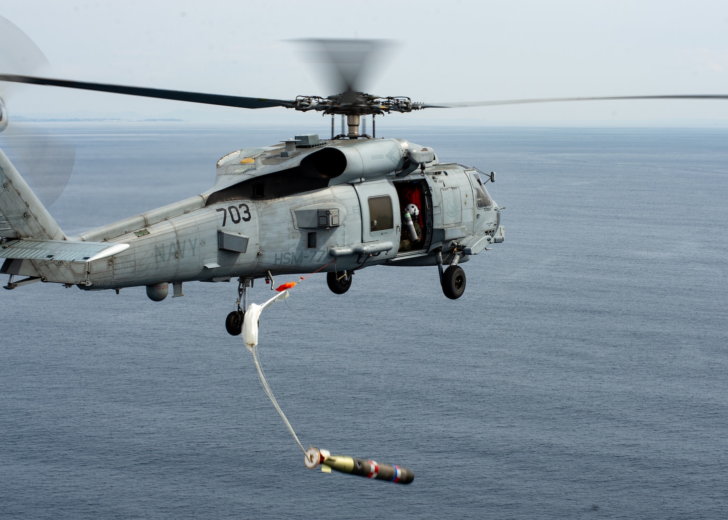 TOKYO BAY (March 10, 2022) An MH-60R Seahawk, attached to the “Saberhawks” of Helicopter Maritime Strike Squadron (HSM) 77, drops a practice torpedo during the first torpedo exercise conducted by a U.S. Navy squadron alongside the JMSDF. HSM-77 is attached to Commander, Task Force 70 and forward-deployed to the U.S. 7th Fleet area of operations in support of a free and open Indo-Pacific. (U.S. Navy photo by Mass Communication Specialist 2nd Class Askia Collins)
