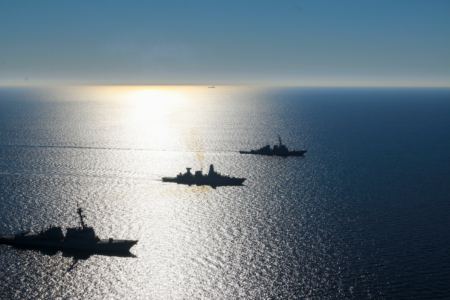 The Arleigh Burke-class guided-missile destroyers USS Forrest Sherman (DDG 98) and USS Donald Cook (DDG 75) conduct maneuvering drills with German Sachsen-class air-defense frigate FGS Sachsen (F219), March 9.