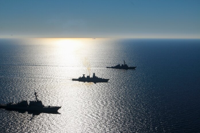 The Arleigh Burke-class guided-missile destroyers USS Forrest Sherman (DDG 98) and USS Donald Cook (DDG 75) conduct maneuvering drills with German Sachsen-class air-defense frigate FGS Sachsen (F219), March 9.