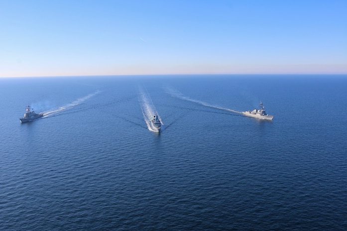 The Arleigh Burke-class guided-missile destroyers USS Forrest Sherman (DDG 98) and USS Donald Cook (DDG 75) conduct maneuvering drills with German Sachsen-class air-defense frigate FGS Sachsen (F219), March 9.