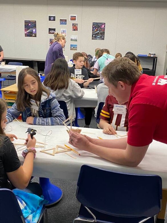 Doing his part to ensure the future of engineering is secure, Middle East District civil engineer Garrison Myers assists 5th grade students with engineering principles and techniques through tips and pointers for their bridge building activity at STARBASE Academy Winchester.