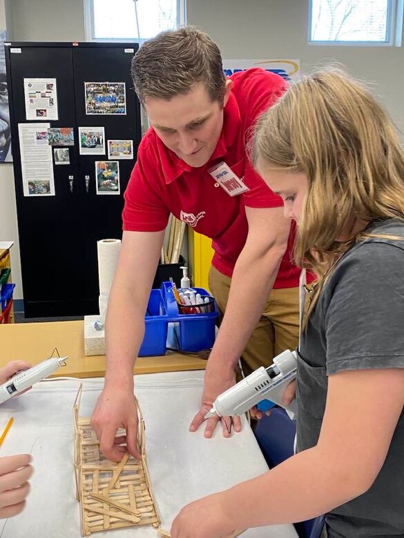 Doing his part to ensure the future of engineering is secure, Middle East District civil engineer Garrison Myers assists 5th grade students with engineering principles and techniques through tips and pointers for their bridge building activity at STARBASE Academy Winchester.