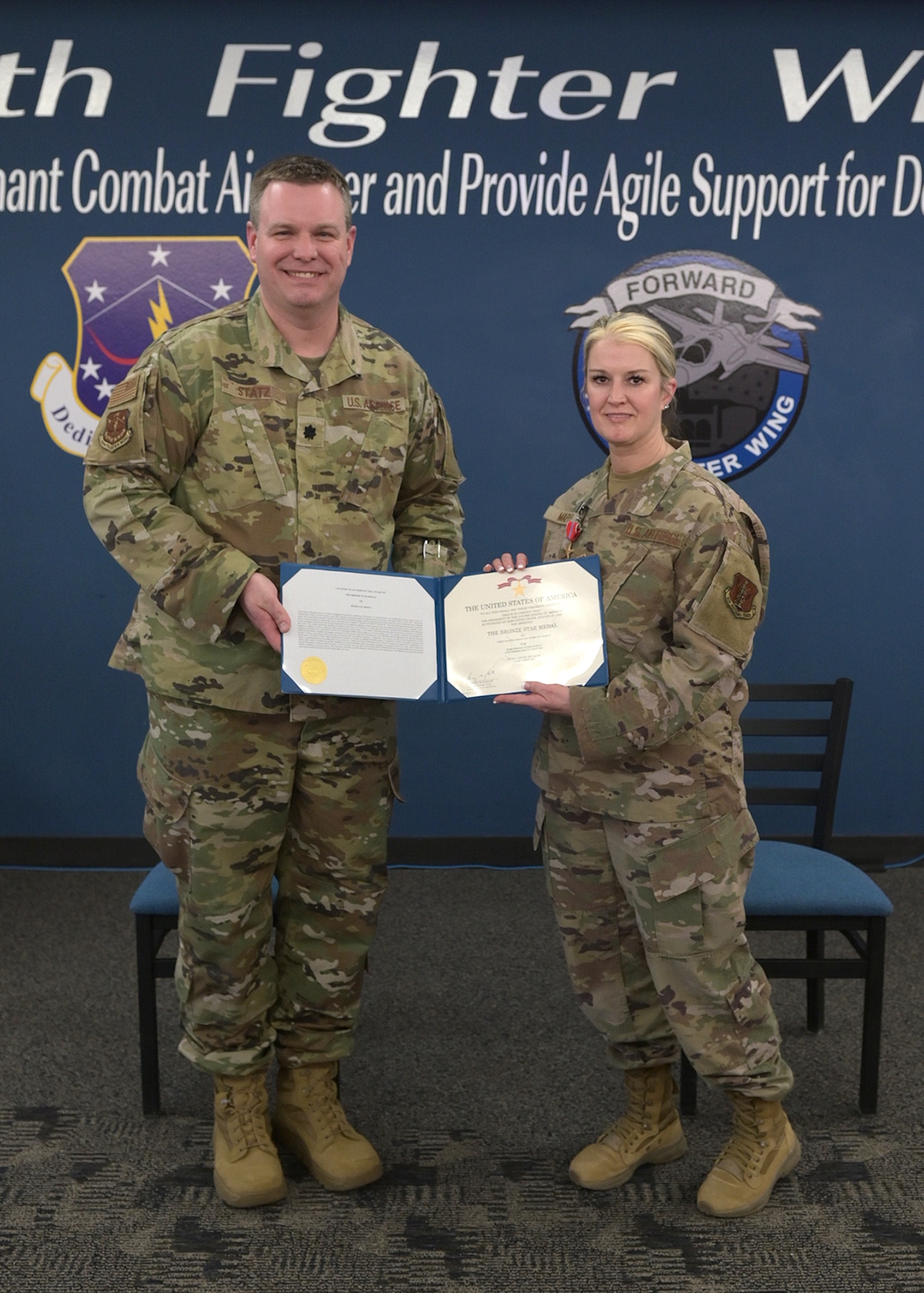 U.S. Air Force Lt. Col. Daniel Statz, commander of the Wisconsin Air National Guard's 115th Mission Support Group, presents the Bronze Star to Chief Master Sgt. Jessica Maple, 115th MSG superintendent March 5, 2022, at Truax Field in Madison, Wisconsin. Maple was awarded the medal for her leadership of a dedicated personnel recovery capability while deployed to Al Asad Airbase, Iraq. (U.S. Air National Guard photo by Tech. Sgt. Andrea Rhode)