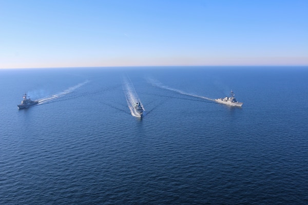 The Arleigh Burke-class guided-missile destroyers USS Forrest Sherman (DDG 98) and USS Donald Cook (DDG 75) conduct maneuvering drills with German Sachsen-class air-defense frigate FGS Sachsen (F219), March 9.