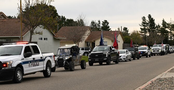 The 30th Security Forces Squadron throw a parade Jan. 29, 2022, on Vandenberg Space Force Base, Calif. The defenders organized the parade that celebrated Grayson Cates’ return home from seven months of treatment for brain cancer. (U.S. Space Force photo by Airman 1st Class Tiarra Sibley)