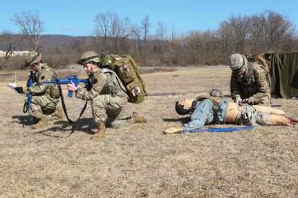 Combat medics with the Pennsylvania National Guard provide security while another renders tactical field care to a simulated casualty as part of the TC8-800 medic sustainment course March 2 at Fort Indiantown Gap, Pennsylvania. The course enabled the 17 participants to train together with other medics outside their home units Feb. 17-March 3.