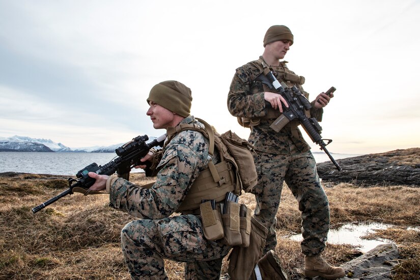 Marines pose with their weapons.