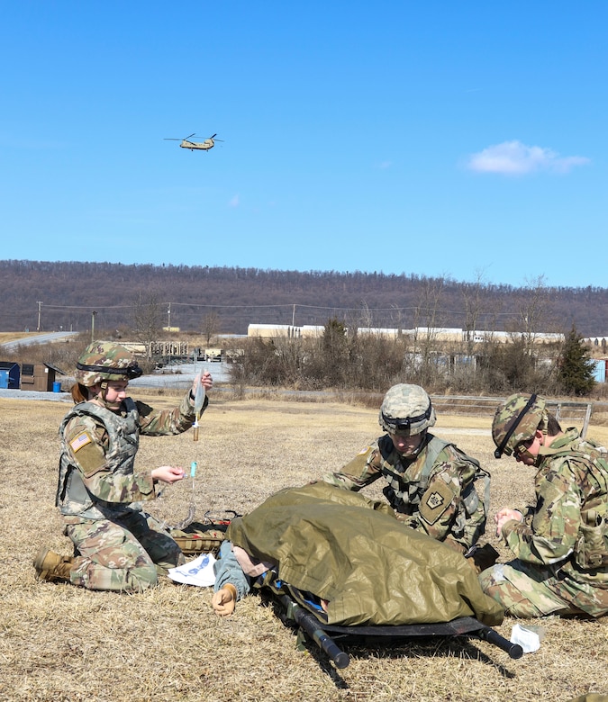 Combat medics with the Pennsylvania National Guard treat a simulated casualty as part of the TC8-800 medic sustainment course March 2 at Fort Indiantown Gap, Pa. The course, which was held Feb. 17-March 3, gave the 17 participants the opportunity to train together with other medics outside their home units, without taking up time during drill weekends where most training is conducted. (U.S. Army National Guard photo by Staff Sgt. Zane Craig)