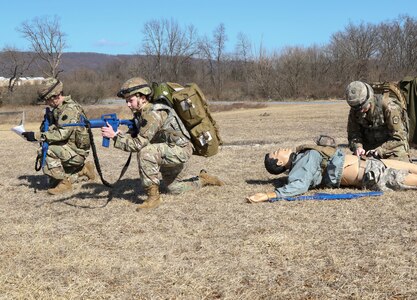 Combat medics with the Pennsylvania National Guard provide security while another renders tactical field care to a simulated casualty as part of the TC8-800 medic sustainment course March 2, 2022, at Fort Indiantown Gap, Pa. The course, which was held Feb. 17-Mar. 3, enabled the 17 participants to train with other medics outside their home units.